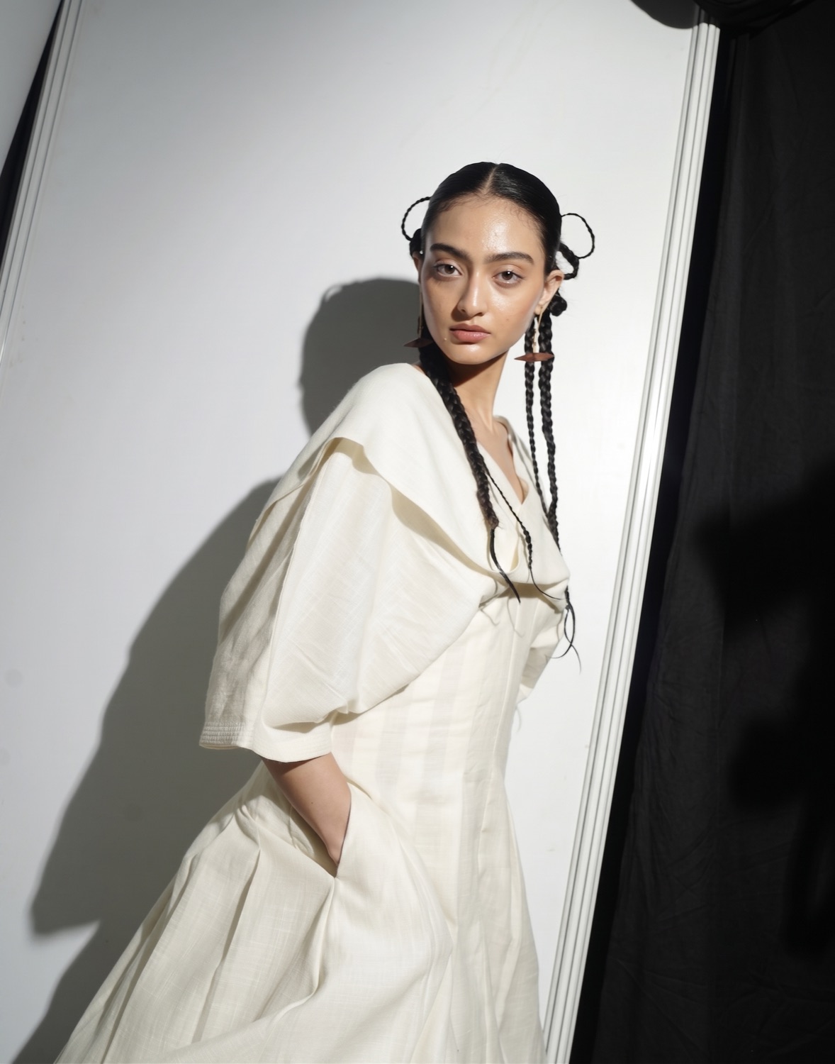 Portrait in soft daylight with braided hair and a fresh, luminous natural finish